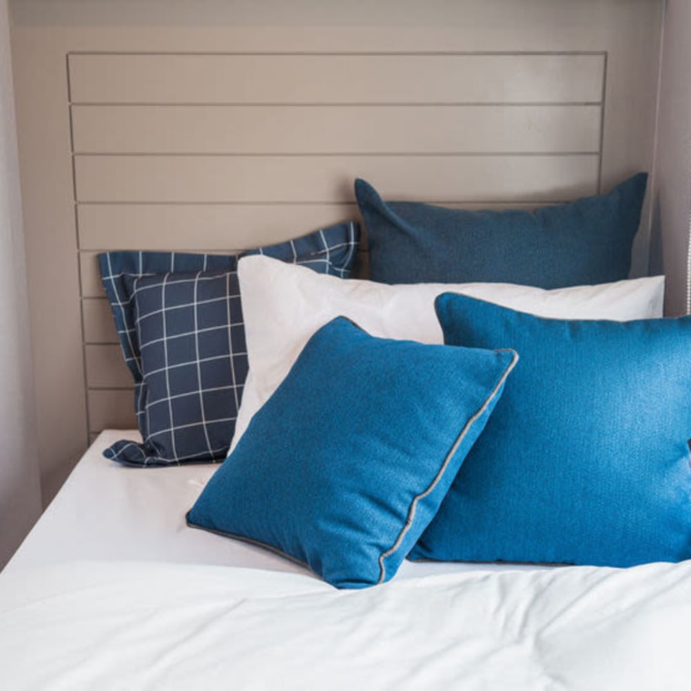Bed with blue accents at Vista Pointe in Covina, California