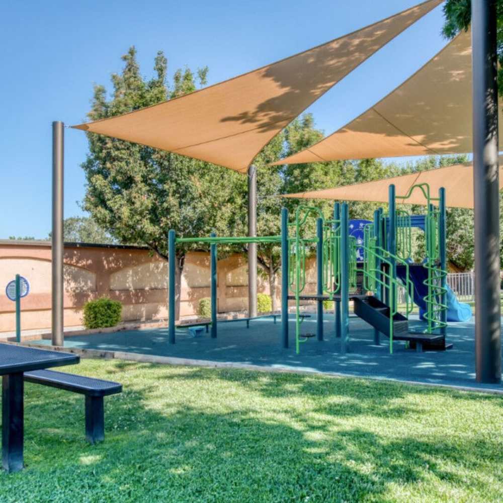 Shaded play area for kids at Ascent Townhome Apartments in Fresno, California