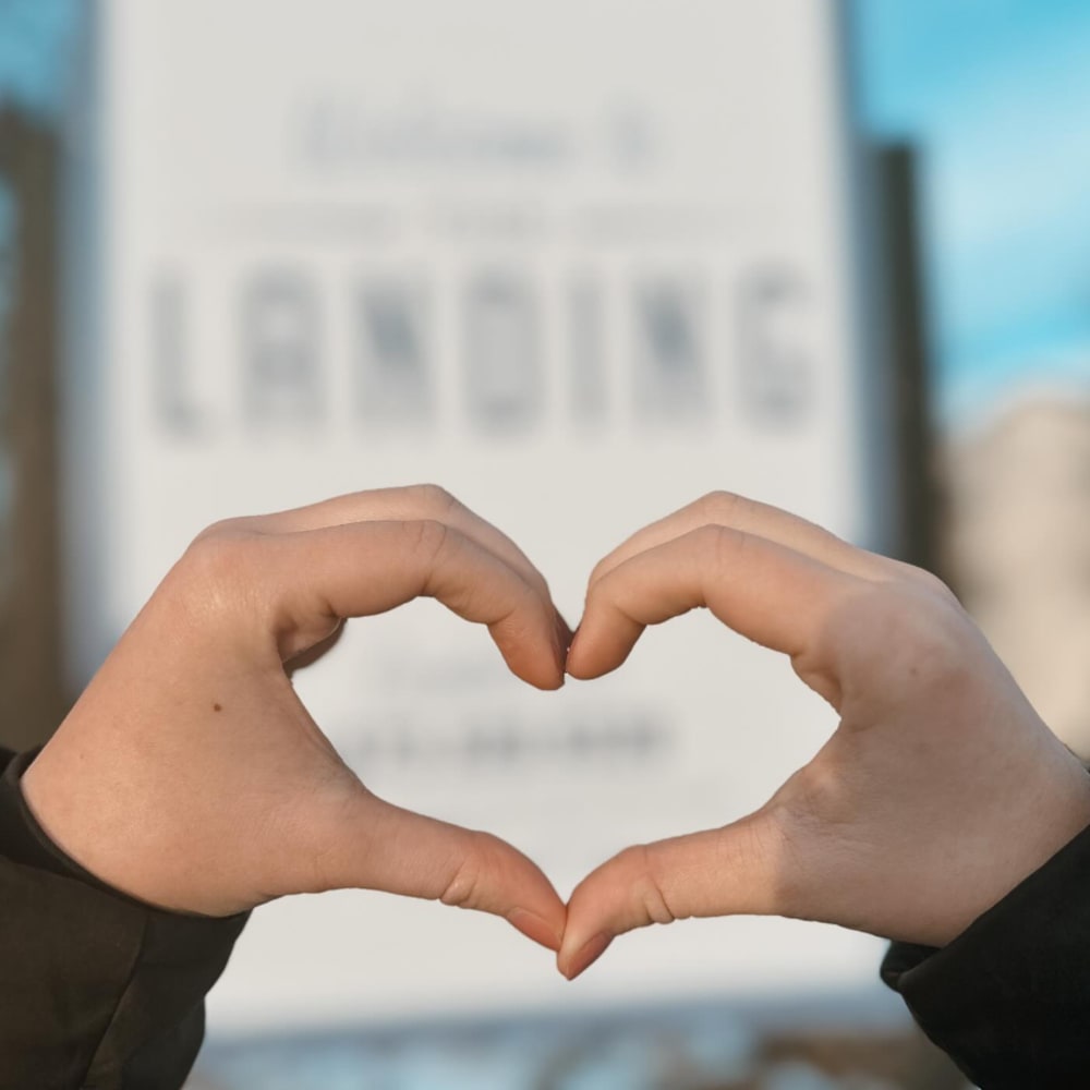 Resident making a heart with hands at The Landing at CoMo in Columbia, Missouri