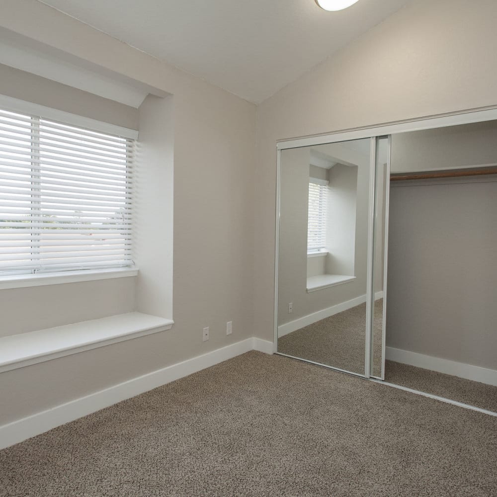Bedroom with mirrored closets at Pacific Vista in Presidio Of Monterey, California