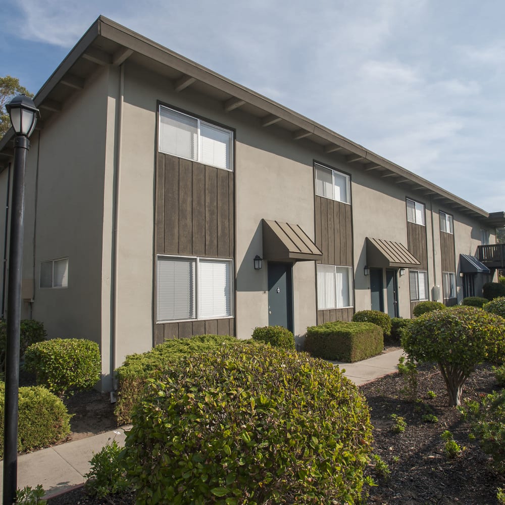Exterior brown apartment building front view at Monterey Townhouse in Monterey, California