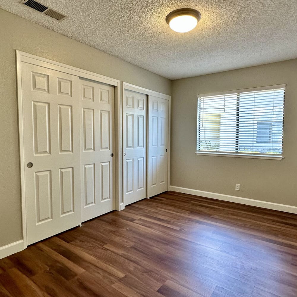 Remodeled bedroom with wood-style flooring at Sheridan Park in Salinas, California