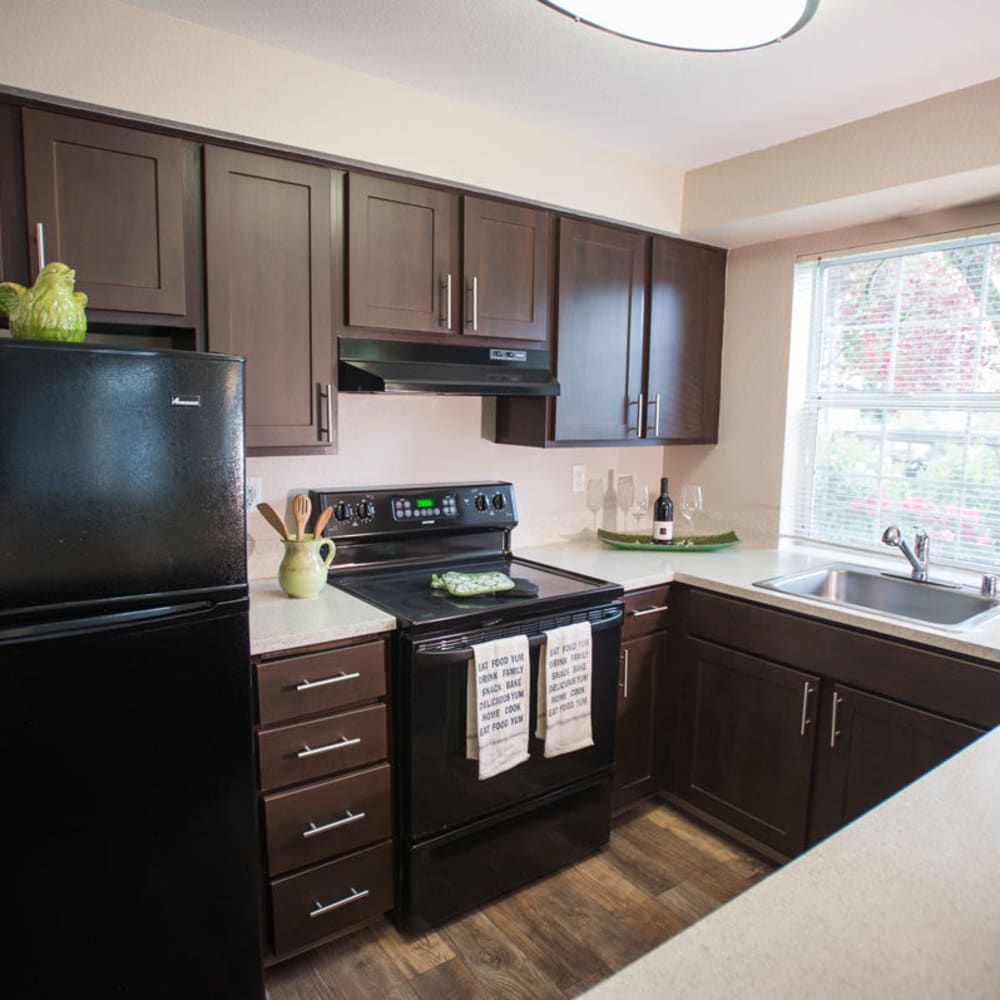 Kitchen with black appliances at The Seasons in Lynnwood, Washington