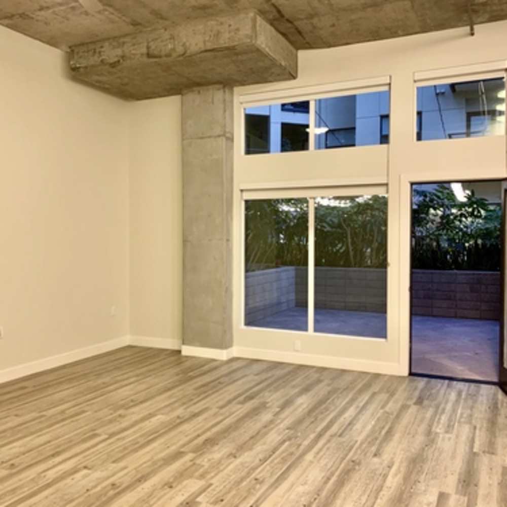 Empty living room with door to outside at Urbana Rental Flats in San Diego, California