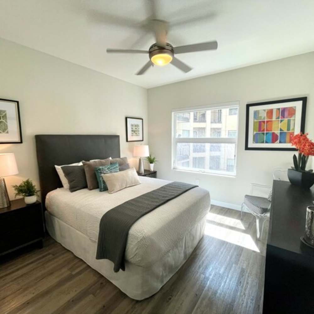 Bedroom with ceiling fan at Urbana Rental Flats in San Diego, California