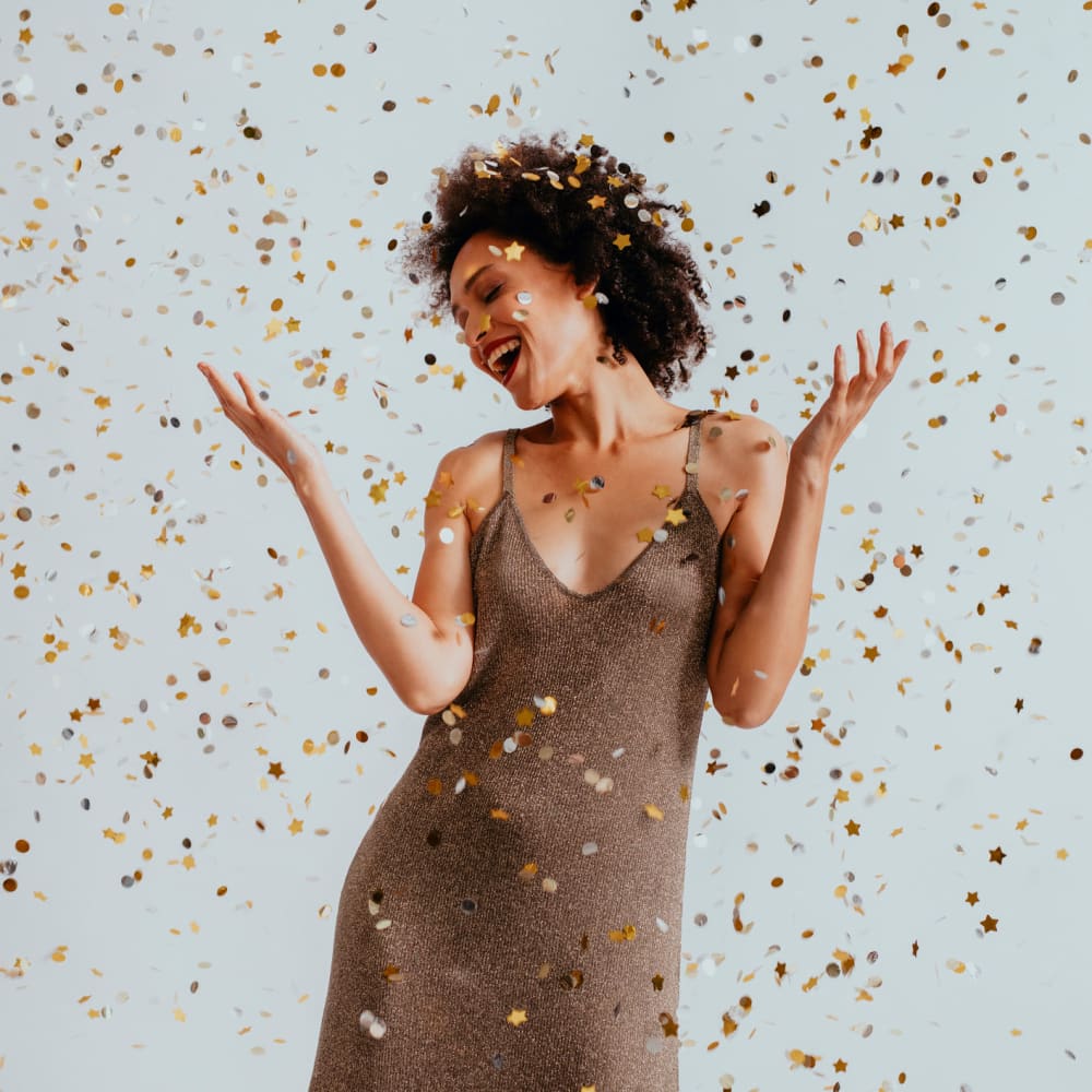 Woman celebrating with confetti at Yarmouth Apartments in Encino, California