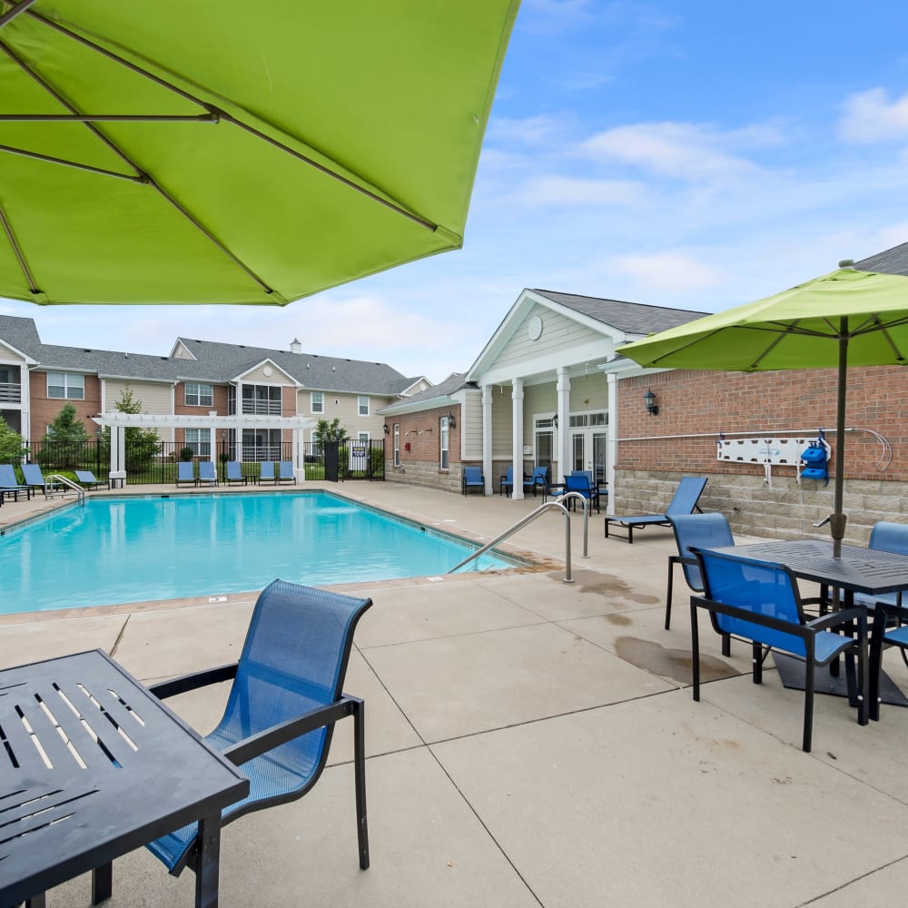 Pool side seating with patio tables and chairs at Cumberland Pointe in Noblesville, Indiana