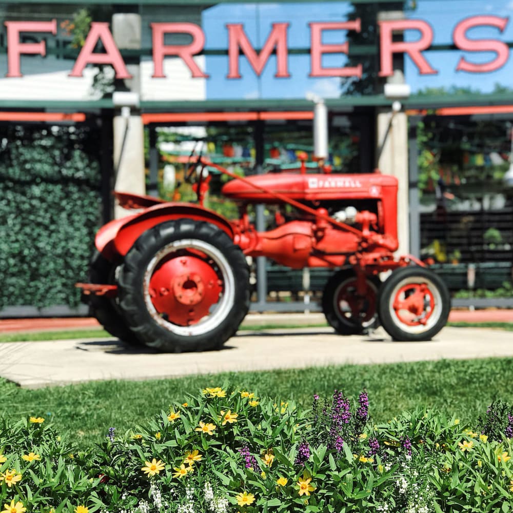 red tractor outside the Dallas Farmers Market near Harvest Lofts in Dallas, Texas