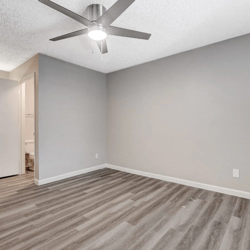 Apartment with wood-style flooring and ceiling fan at Tides on Twain in Las Vegas, Nevada