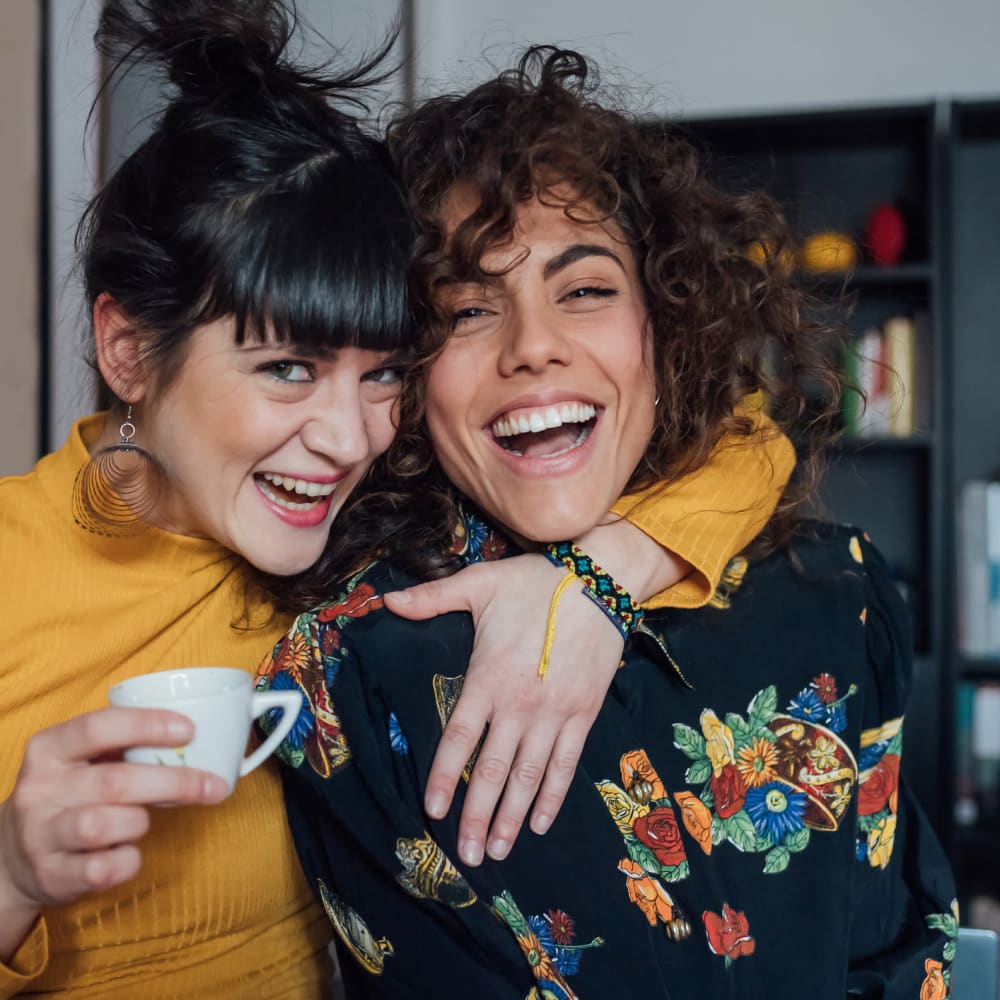 Two women hamming it up for the camera at Sharp Leadenhall Apartments in Baltimore, Maryland