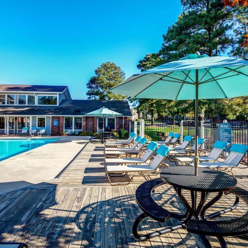 Pool side patio table with umbrellas at Duraleigh Woods in Raleigh, North Carolina