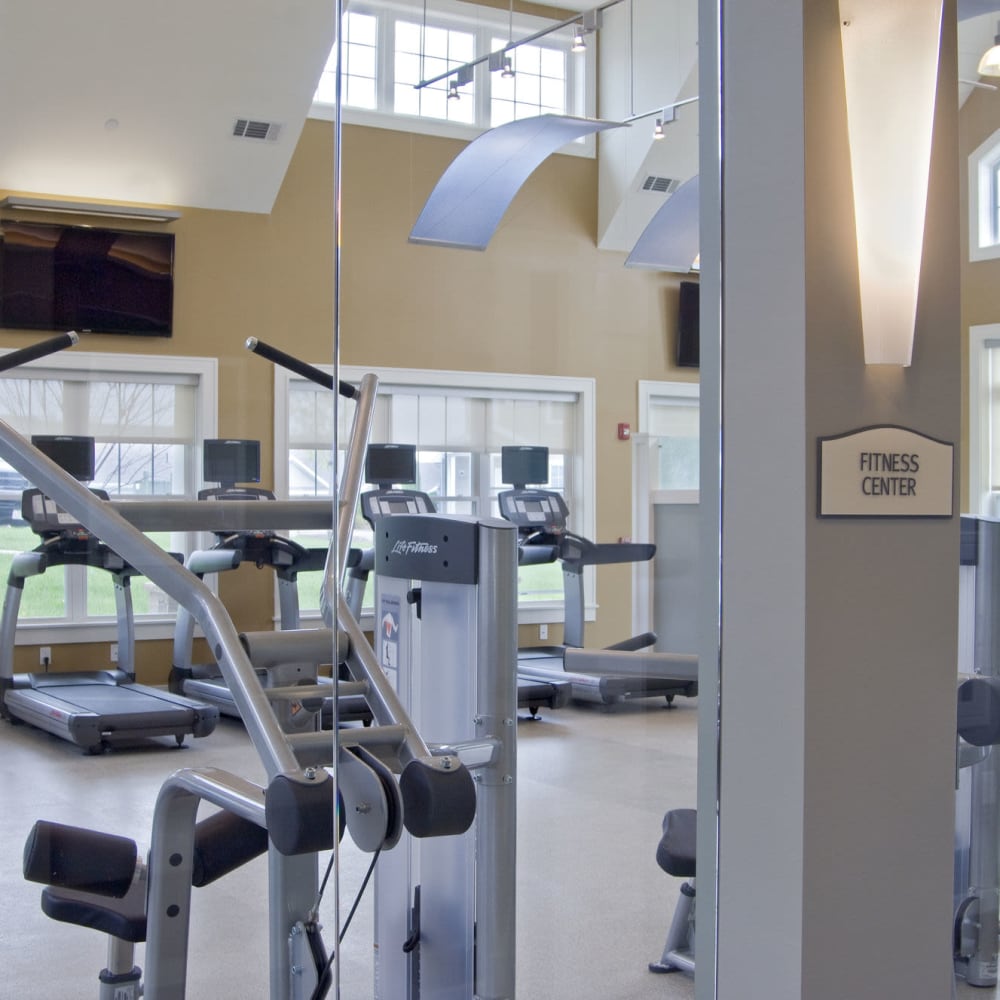 Fitness center with lots of windows at The Preserve at Cohasset in Cohasset, Massachusetts