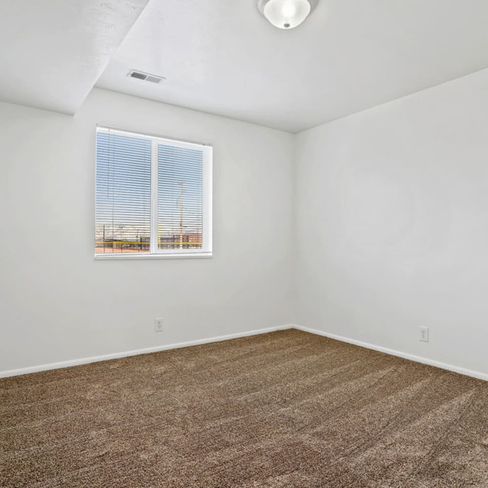 An apartment bedroom with plush carpeting at Chadds Ford Apartments in Midvale, Utah