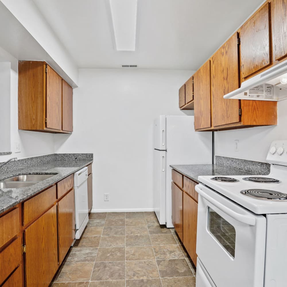 White appliances in an apartment kitchen at Chadds Ford Apartments in Midvale, Utah