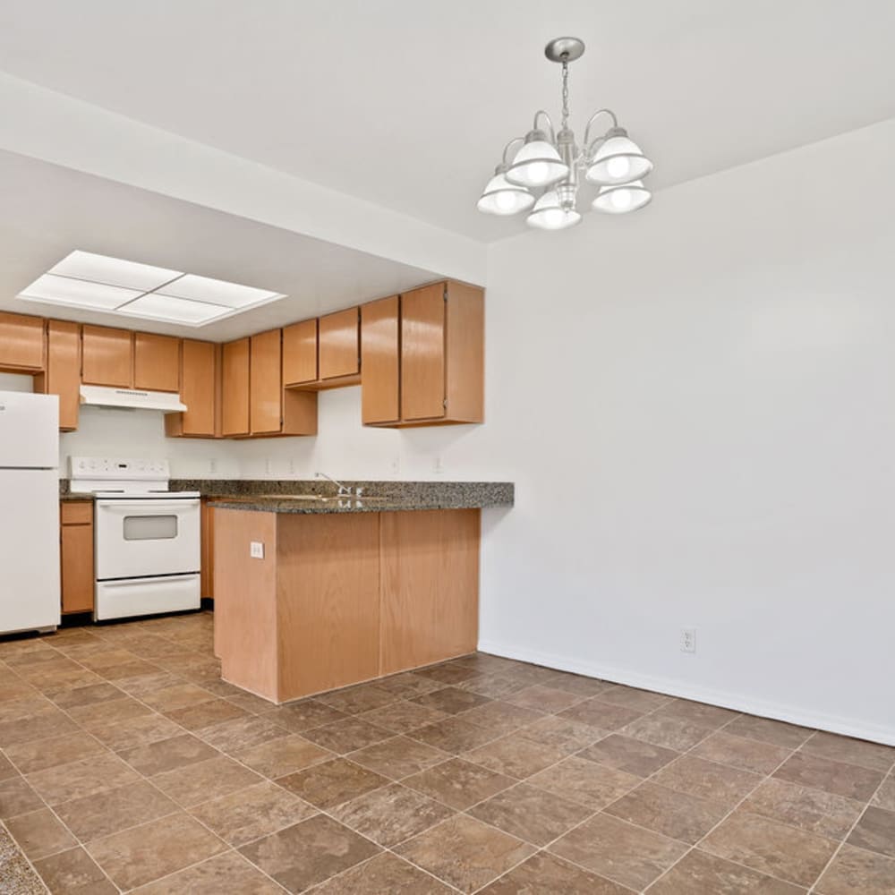 An apartment kitchen and dining room at Clinton Towne Center Apartments in Clinton, Utah