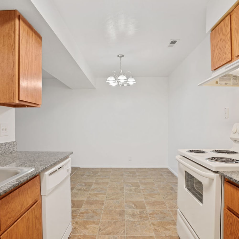 White appliances in an apartment kitchen at Highland Pointe Apartments in Cottonwood Heights, Utah