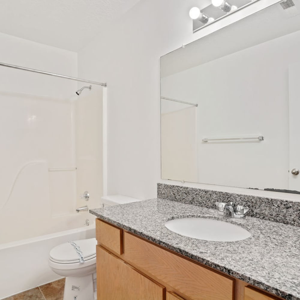 An apartment bathroom with a bathtub at Highland Pointe Apartments in Cottonwood Heights, Utah