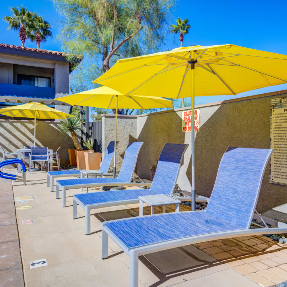 Pool chairs with umbrellas at The Pointe at South Mountain in Phoenix, Arizona