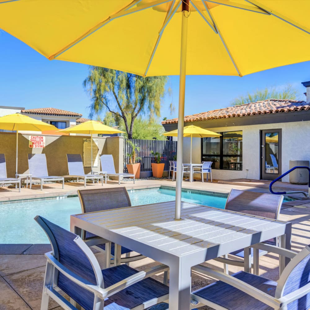 Patio table with chairs and an umbrella at The Pointe at South Mountain in Phoenix, Arizona