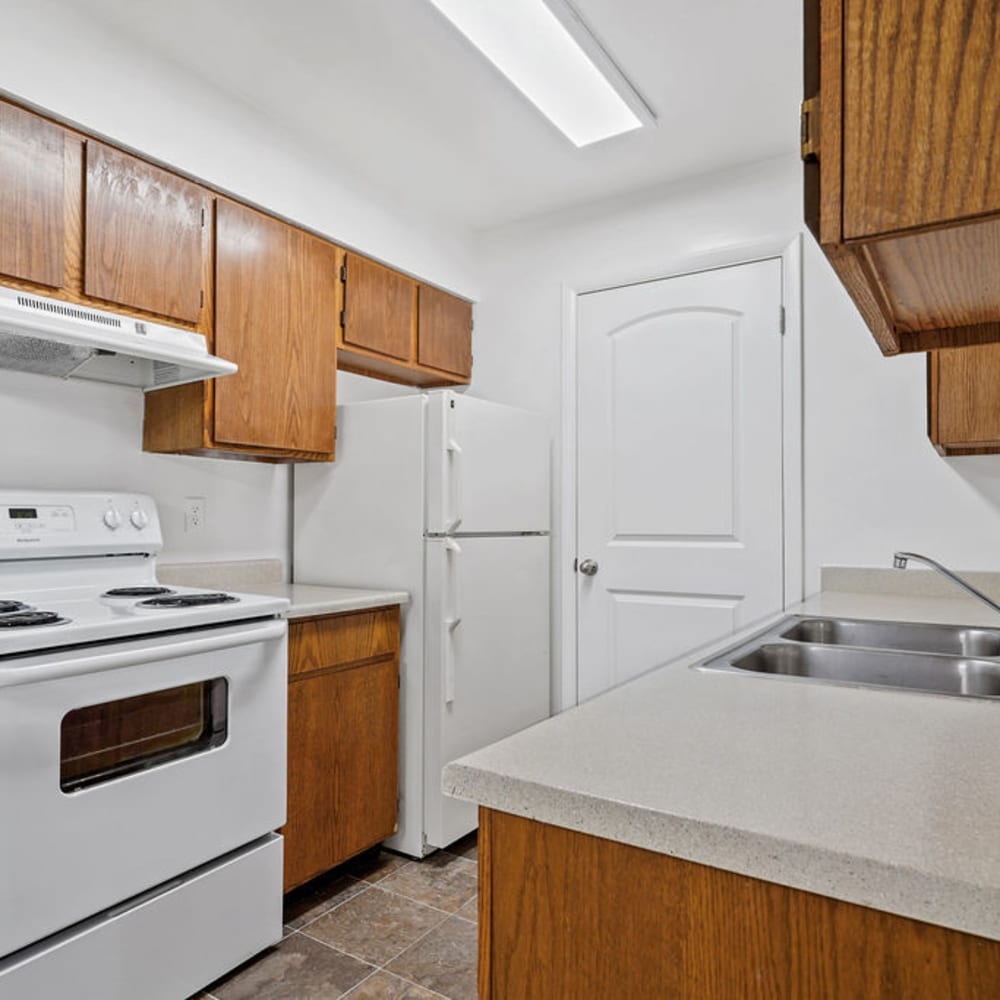 White appliances in an apartment kitchen at Mallard Crossing Apartments in Millcreek, Utah