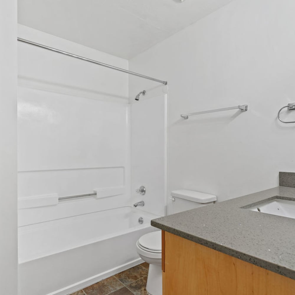An apartment bathroom with a full-sized bathtub at Mallard Crossing Apartments in Millcreek, Utah