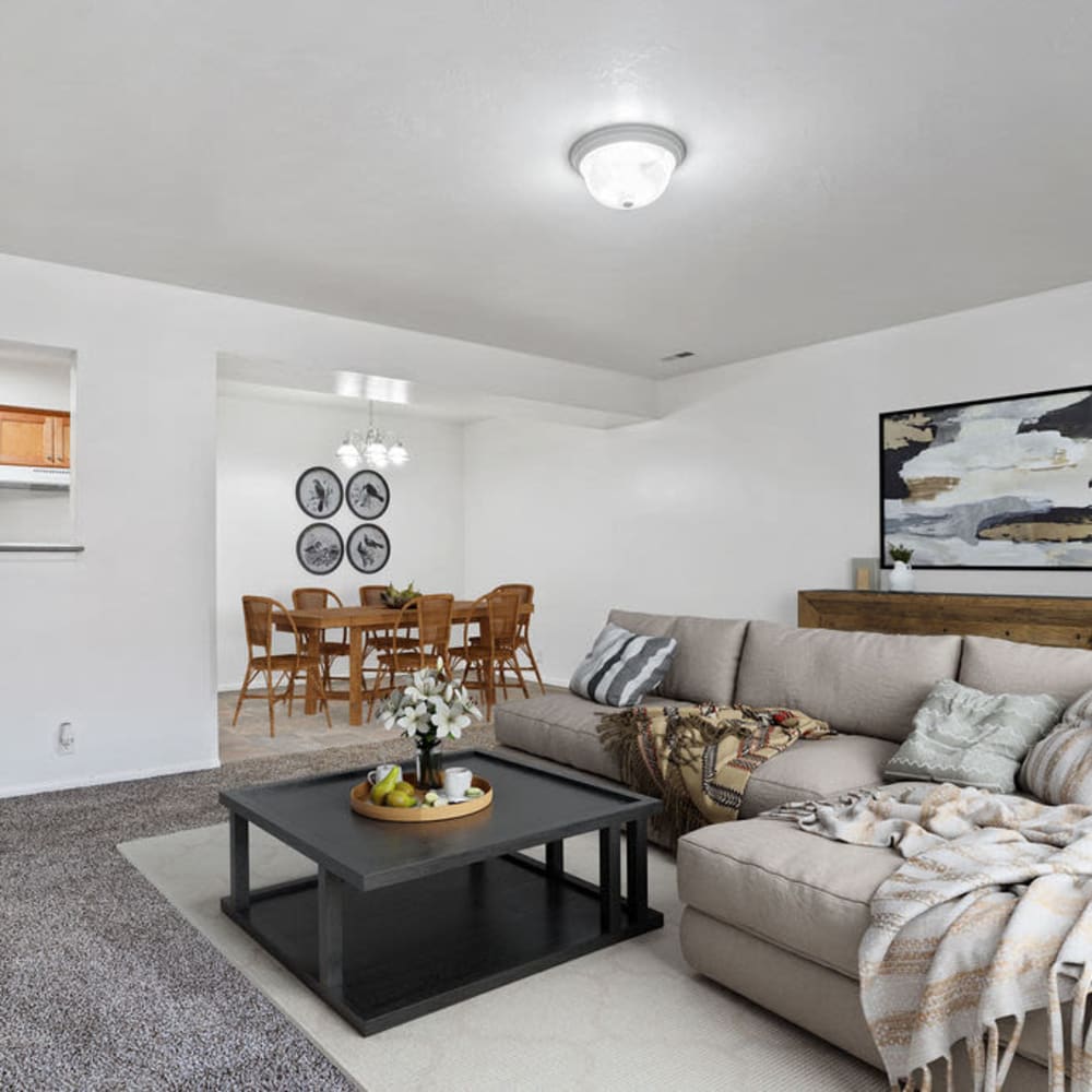 A furnished apartment living room and dining room at Mallard Crossing Apartments in Millcreek, Utah