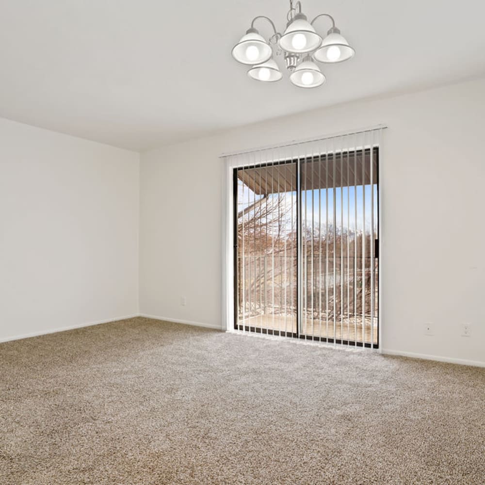 A bright living room with a sliding door to the balcony at Regency Apartments in Salt Lake City, Utah