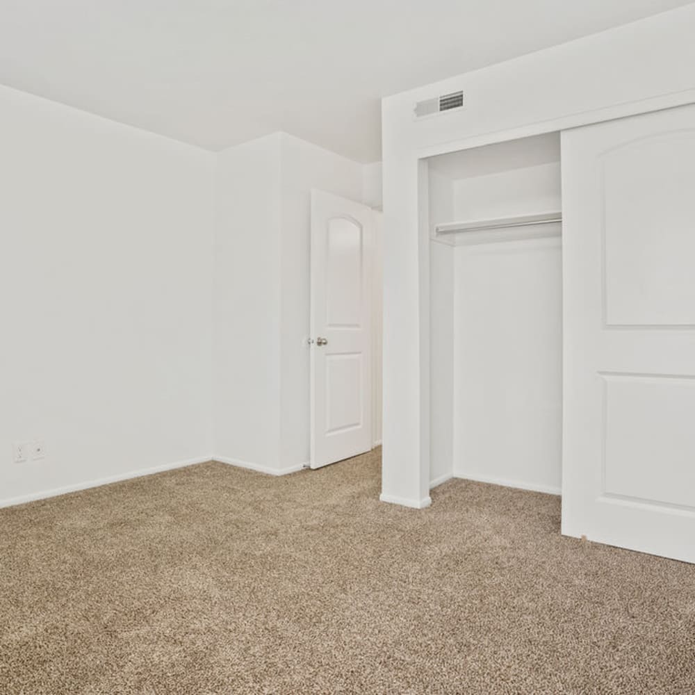 An apartment bedroom with the closet door open at Regency Apartments in Salt Lake City, Utah