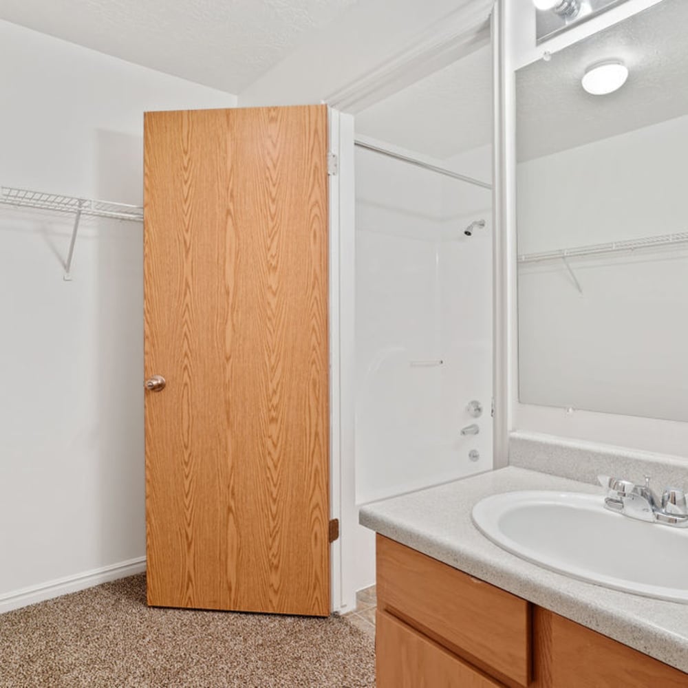 An apartment bedroom with a bathtub at Stonebridge Apartments in West Jordan, Utah