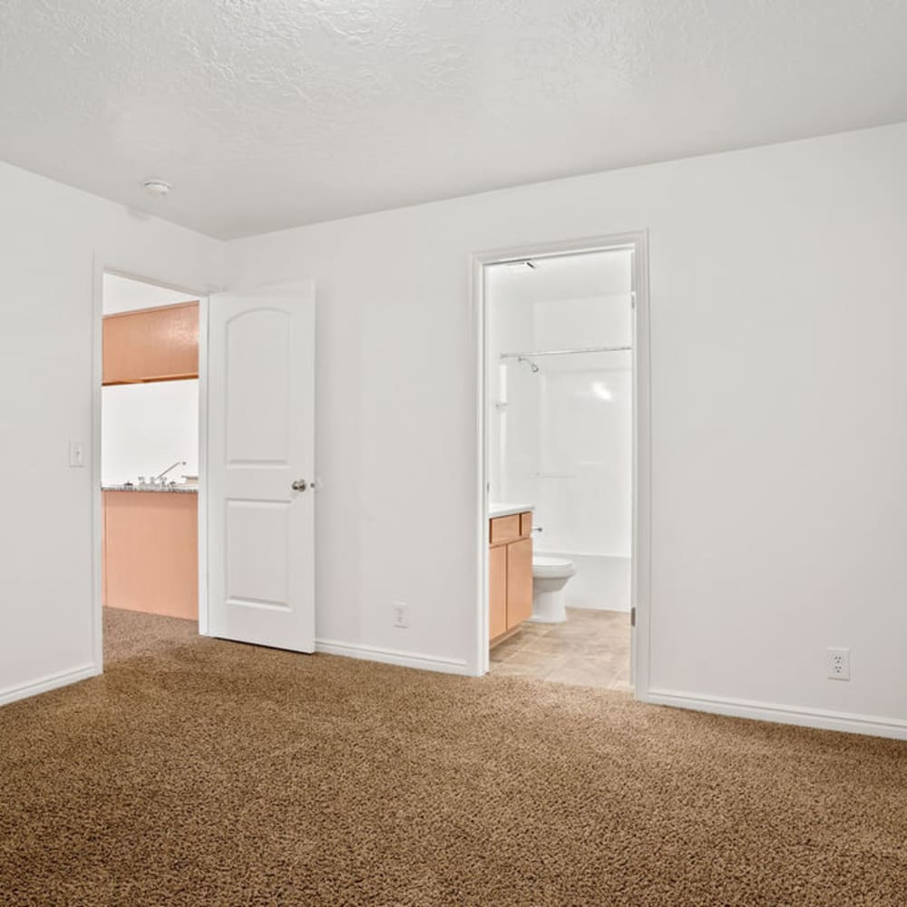 An apartment bedroom with an attached bathroom at Stonebridge Apartments in West Jordan, Utah