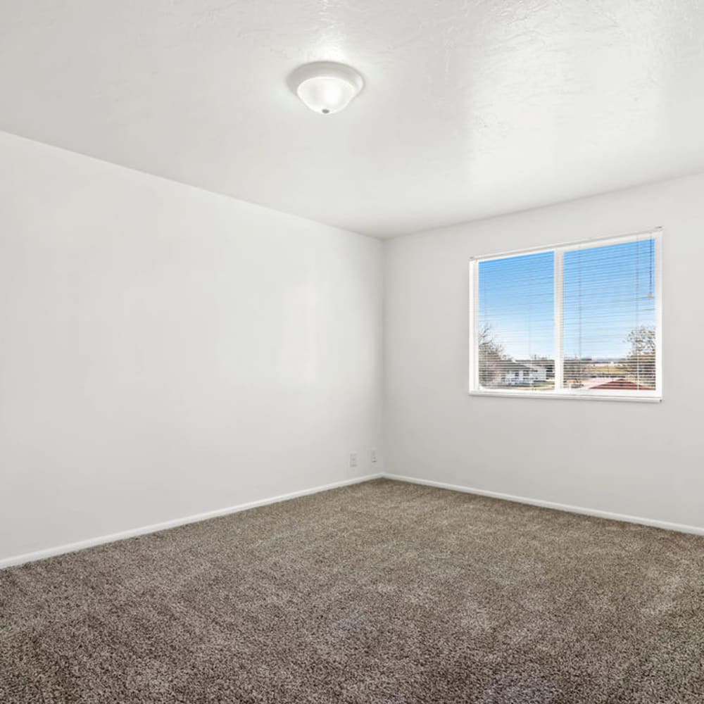 An apartment bedroom with a window at Valley Park Apartments in Salt Lake City, Utah