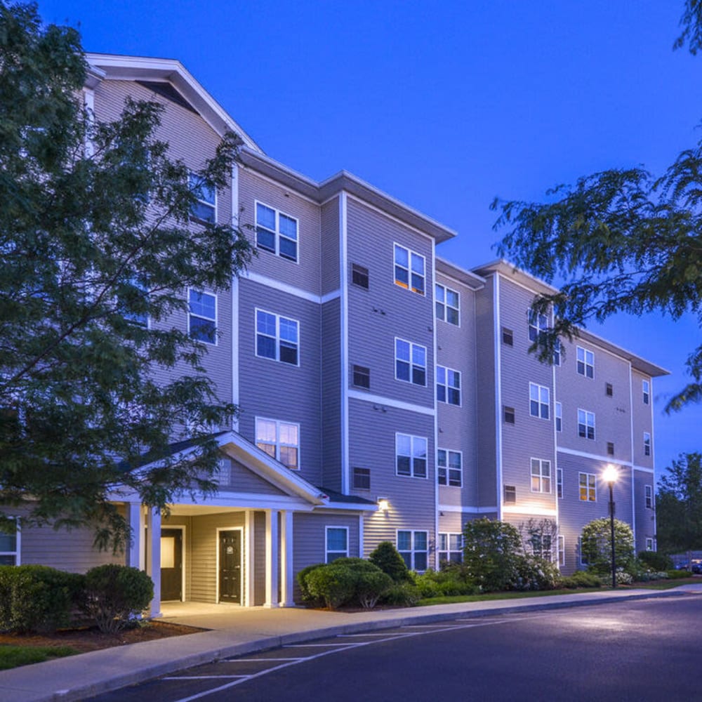 Apartment building exterior at night at Lux at Stoughton in Stoughton, Massachusetts