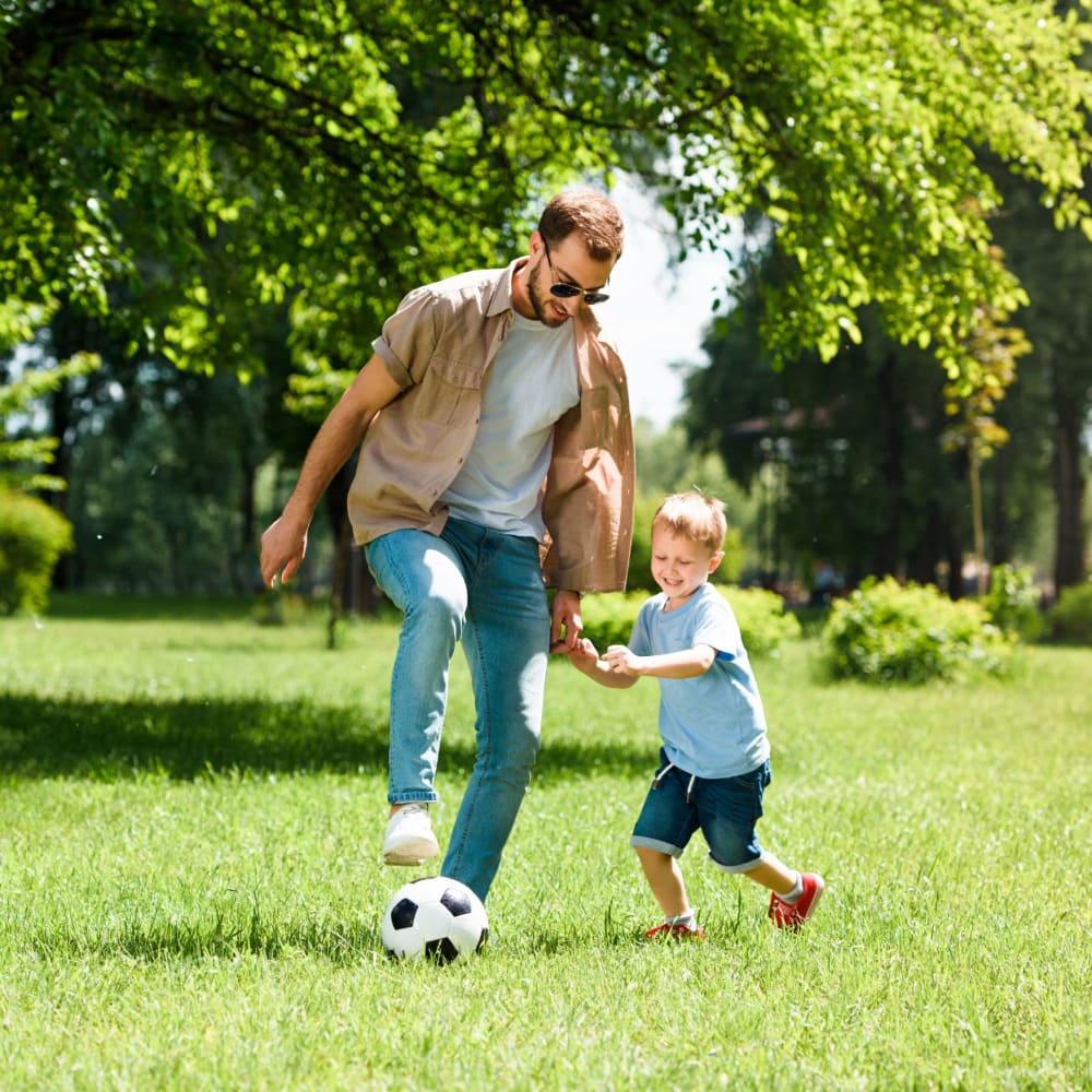 Resident father and son playing soccer in a park near The Armory in Bethlehem, Pennsylvania