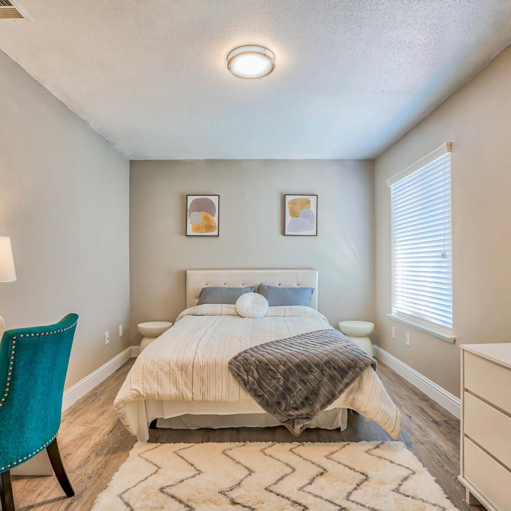 Bedroom with modern furniture at Ascent Townhome Apartments in Fresno, California