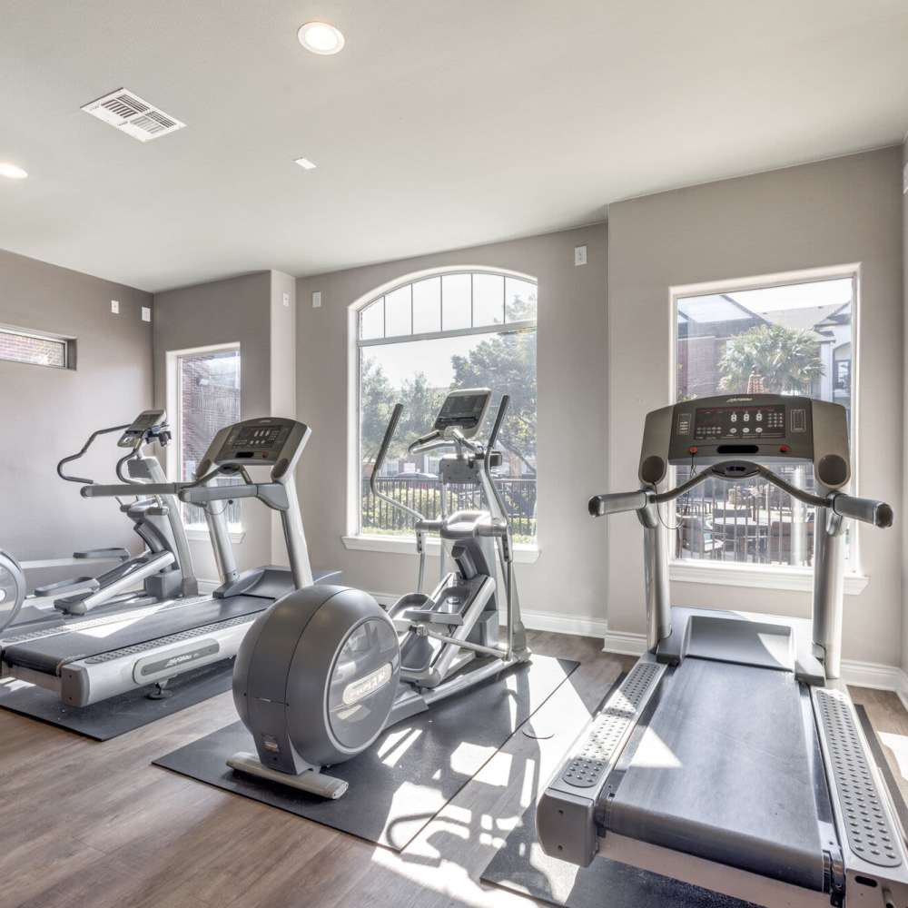 Fitness center with treadmills at Oak Crest in Houston, Texas