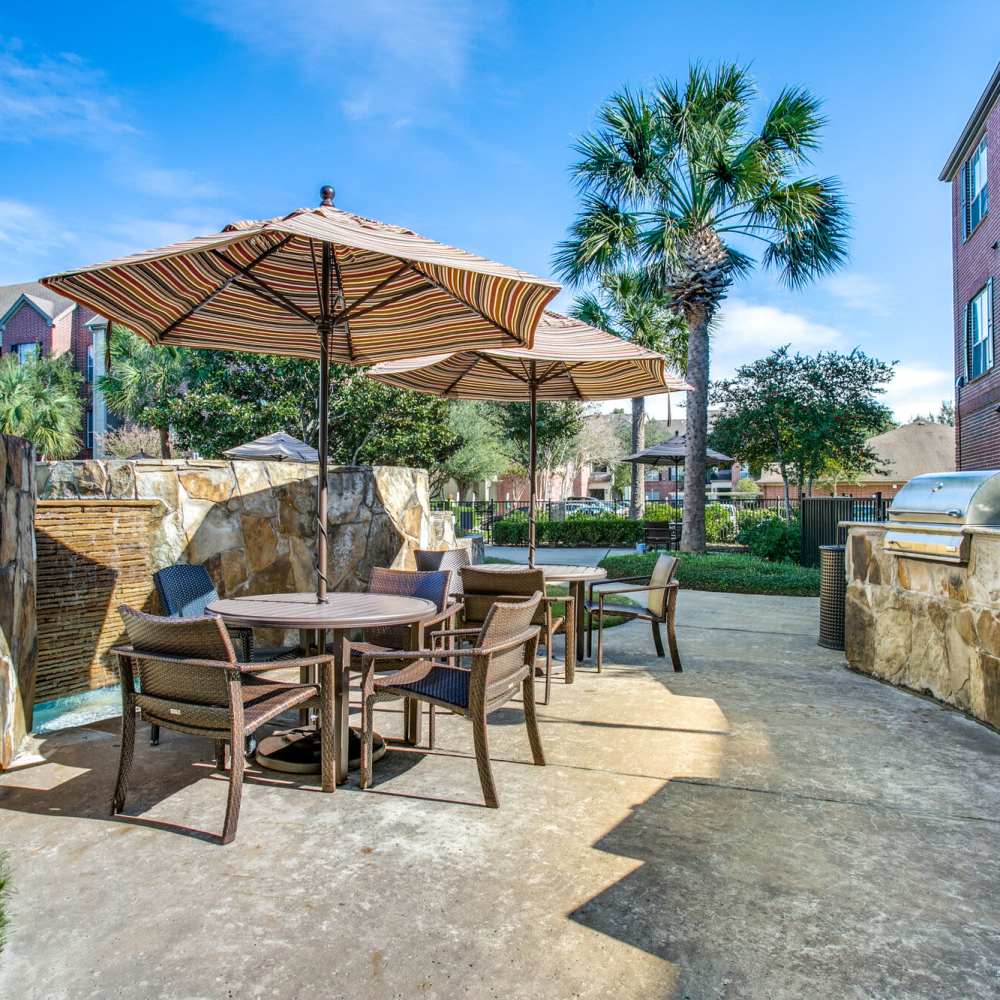 Patio tables with umbrellas at Oak Crest in Houston, Texas