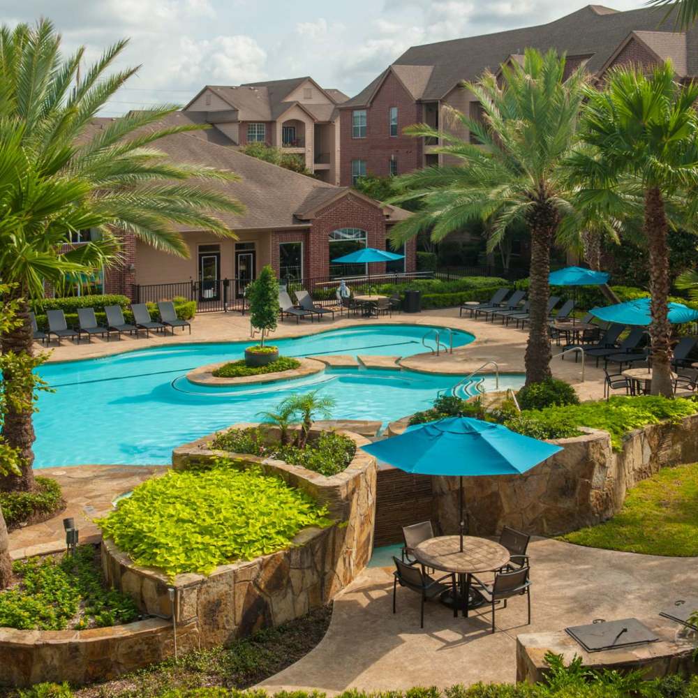 Swimming pool area beautifully manicured at Oak Crest in Houston, Texas