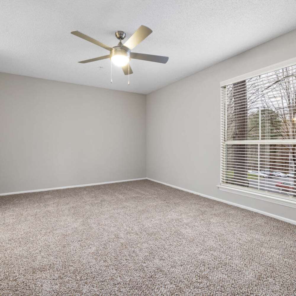 Bedroom with a ceiling fan at Concord Apartments in Raleigh, North Carolina