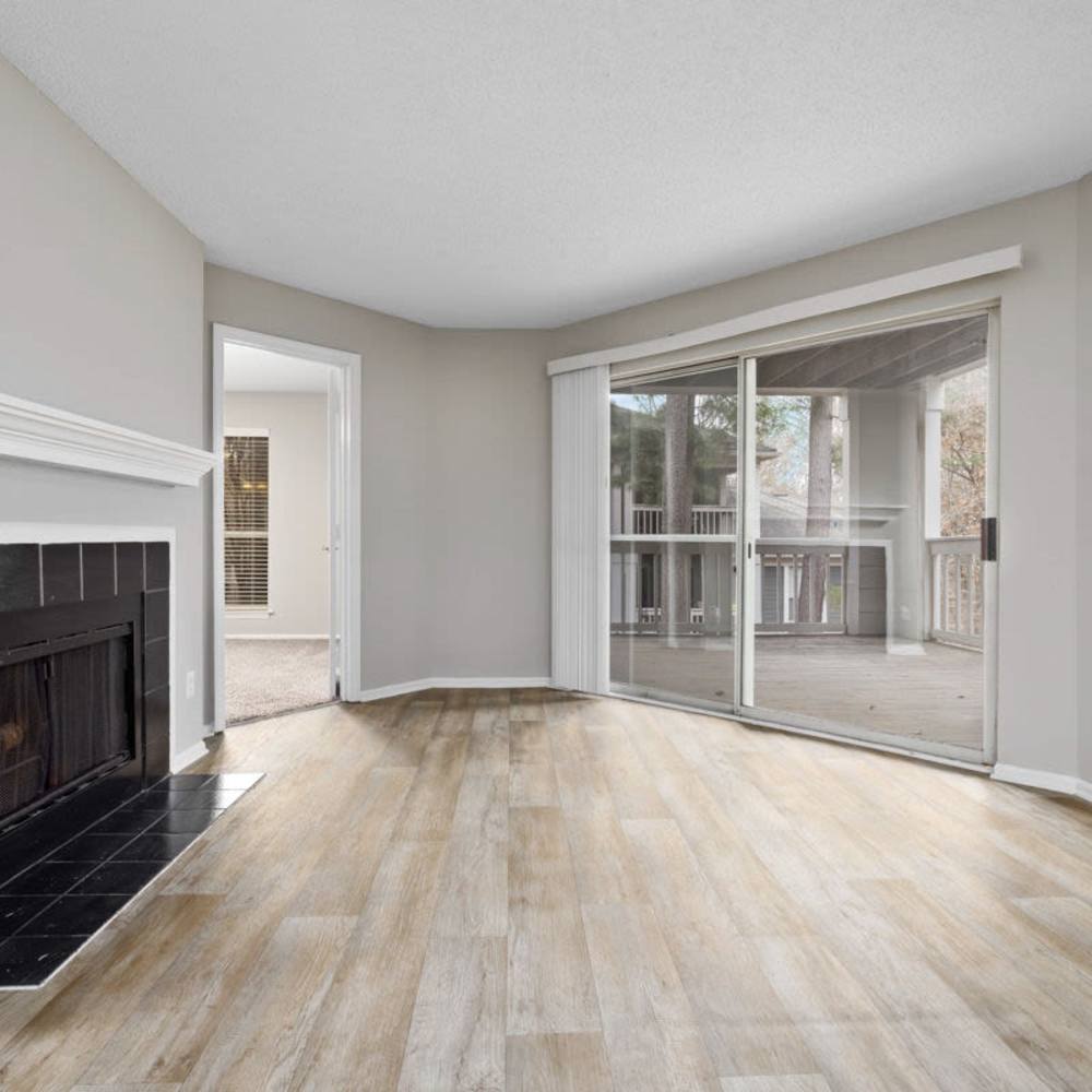 Living space with wood-style flooring at Concord Apartments in Raleigh, North Carolina
