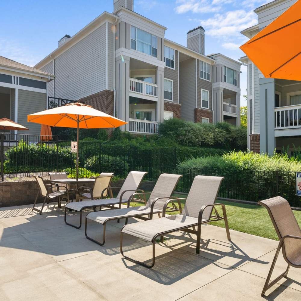 Tables with umbrellas at Concord Apartments in Raleigh, North Carolina