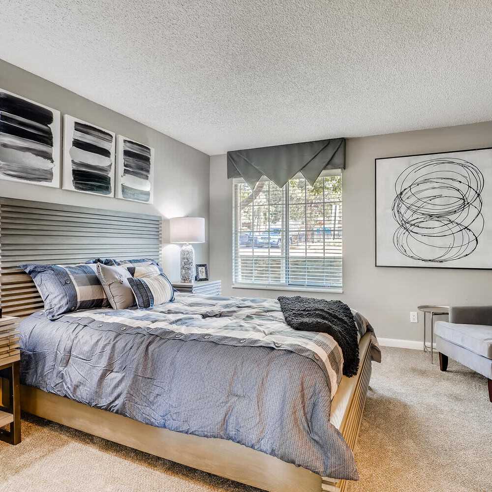 Bedroom with a bed and nightstand at Loretto Heights in Denver, Colorado