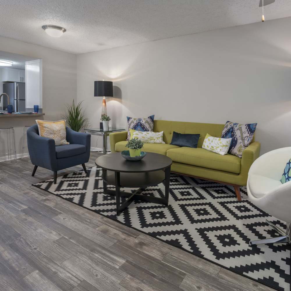 Living space with a sofa and chairs at Four Lakes at Clearwater in Clearwater, Florida
