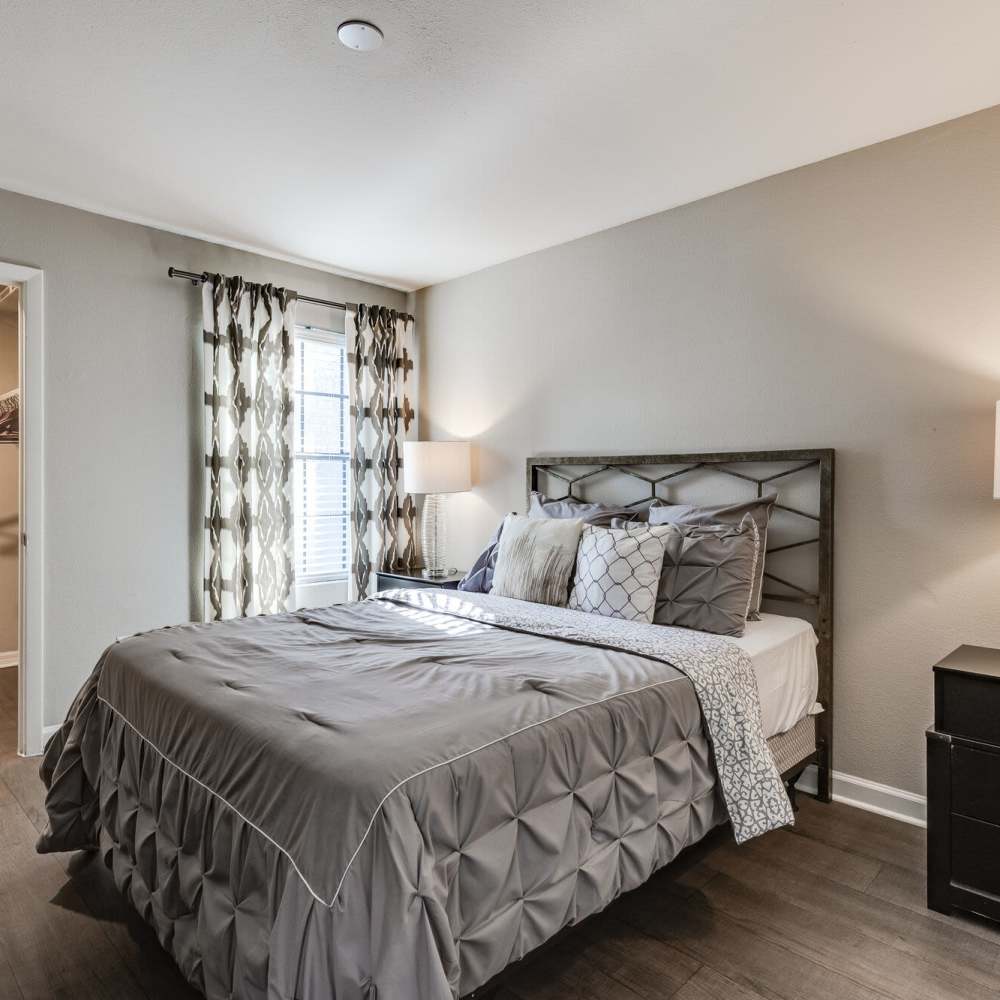 Bedroom with a bed and nightstand at Fourteen01 Apartments in Orlando, Florida