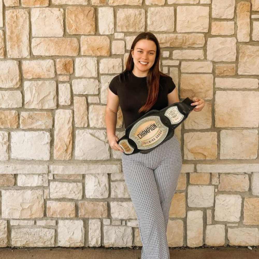 Resident posing with a wrestling belt at The Quarters at Lawrence in Lawrence, Kansas