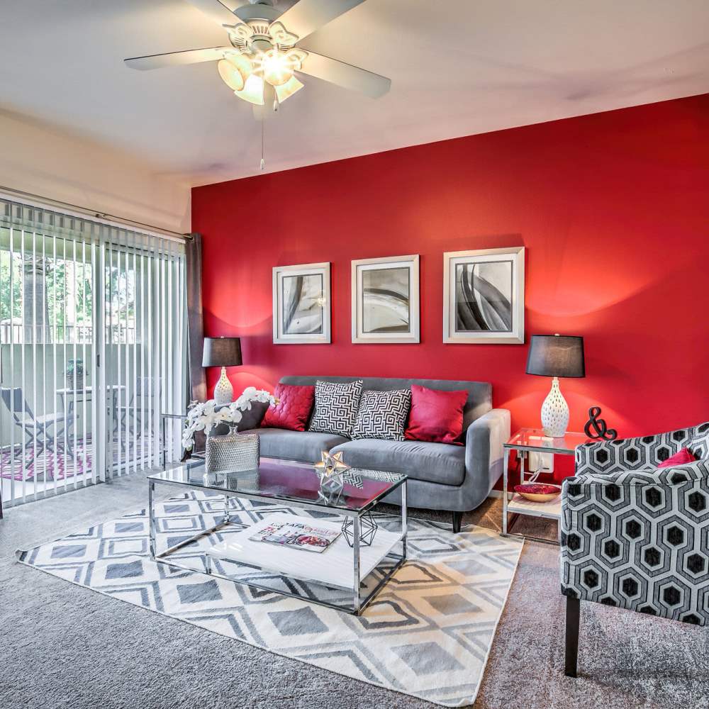 Living space with plush carpeting at Calypso Apartments in Las Vegas, Nevada