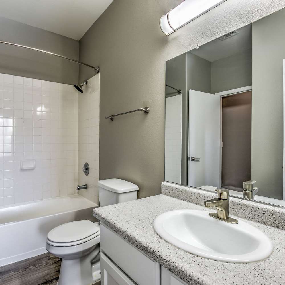 Bathroom with a tub and shower at Calypso Apartments in Las Vegas, Nevada