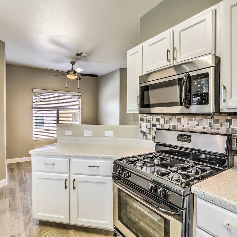 Kitchen with stainless-steel appliances at Calypso Apartments in Las Vegas, Nevada