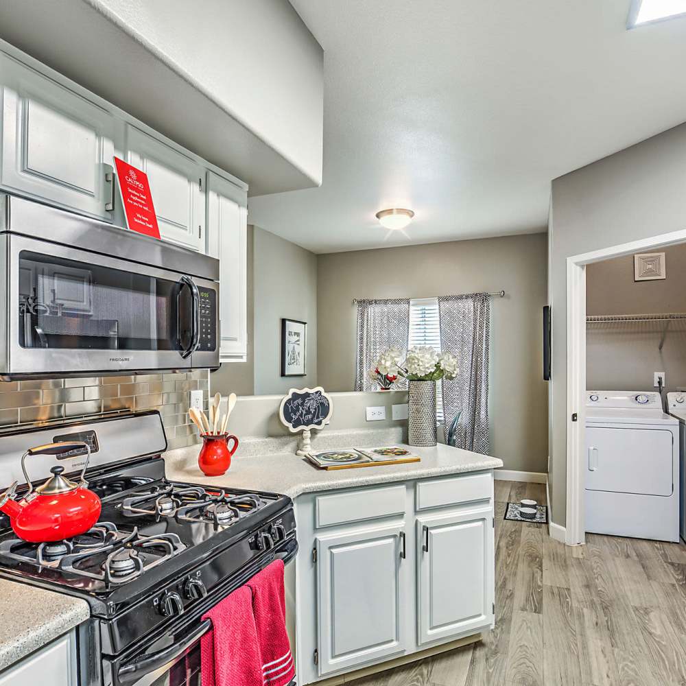 Kitchen with wood-style flooring at Calypso Apartments in Las Vegas, Nevada