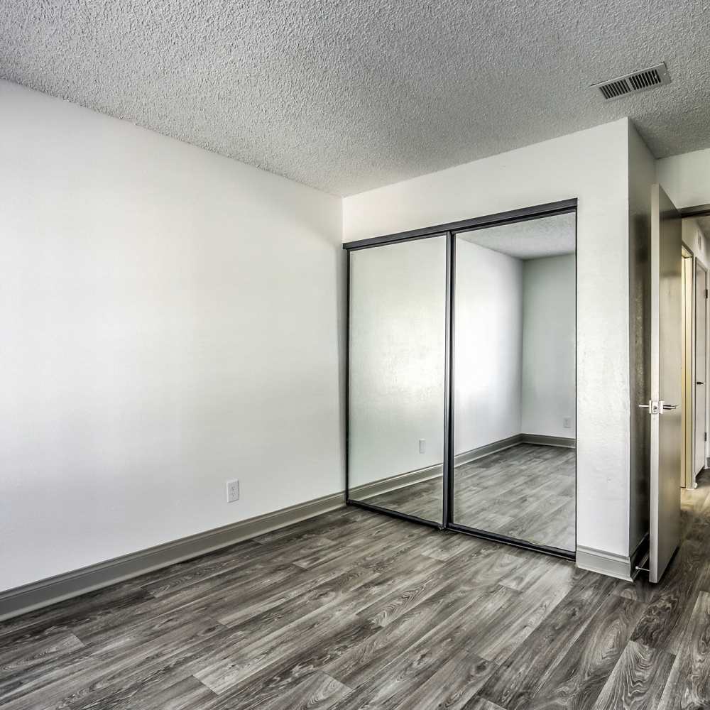 Bedroom with mirrored closet doors at Kaleidoscope in Las Vegas, Nevada