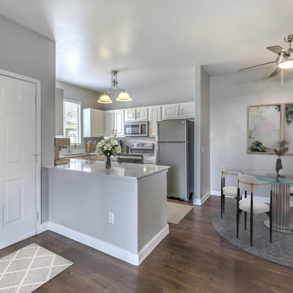 Kitchen and dinning space with wood-style flooring at Aviata in Las Vegas, Nevada